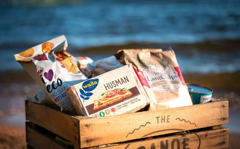 Holzkiste voller schwedischer Snacks an einem Strand